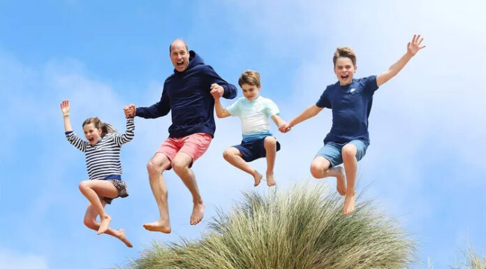 Princ William skače od veselja na plaži z otroki na fotografiji za svoj 42. rojstni dan